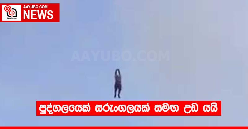 පුද්ගලයෙක් සරුංගලයක් සමඟ උඩ යයි